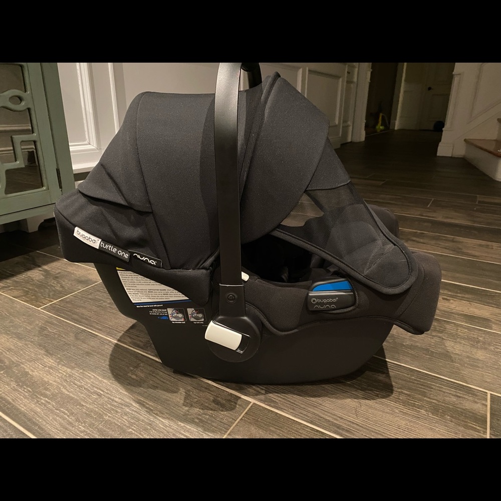 Bugaboo infant car seat with adapter for car.